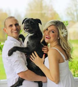 couple hugging their dog